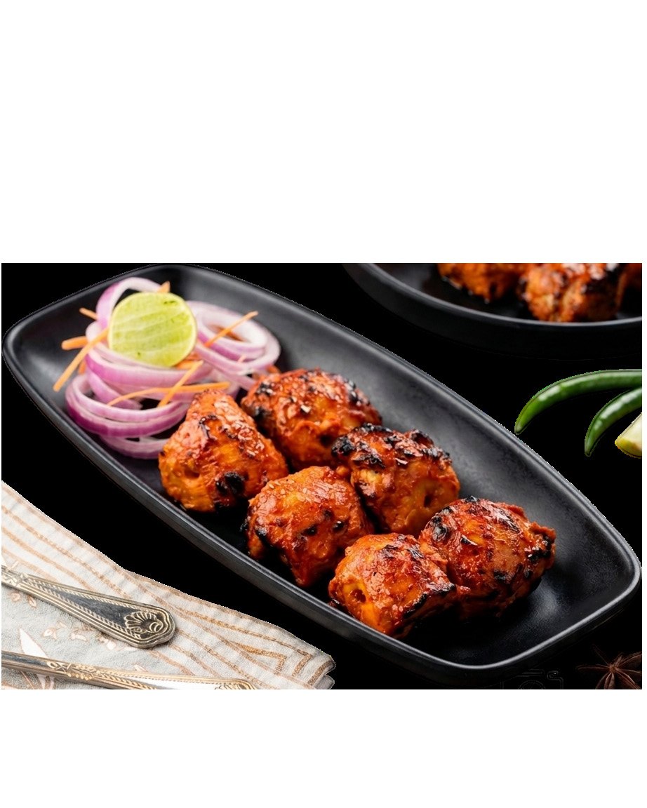 Tandoori chicken kebabs on a black platter