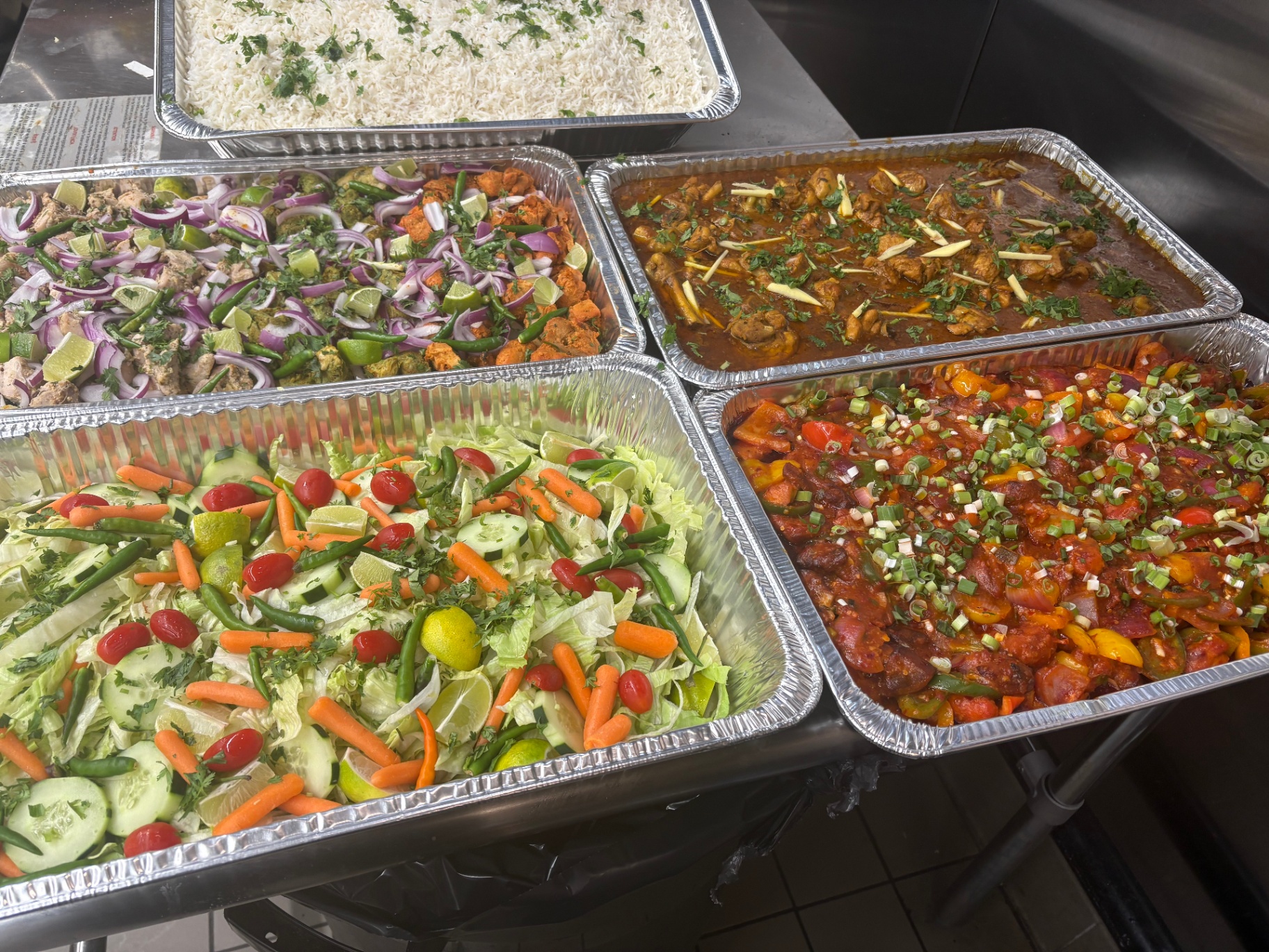 Subzi Mandi catering spread — fresh trays of rice, curry, kebabs and salad